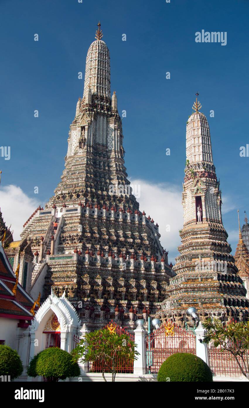 Thailand: The Khmer-style central prang at Wat Arun (Temple of Dawn), Bangkok.  Wat Arun Rajwararam (Temple of the Dawn), full name Wat Arunratchawararam Ratchaworamahawihan, is a Thai Buddhist temple on the Thonburi west bank side of the Chao Phraya River in Bangkok. It is named after Aruna, the Indian God of Dawn. A monastery has stood here since the Ayutthayan period (1351 - 1767), but the temple's outstanding feature, the Khmer-style central prang, was not begun until 1809, during the reign of King Buddha Loetla Nabhalai (Rama II). Stock Photo