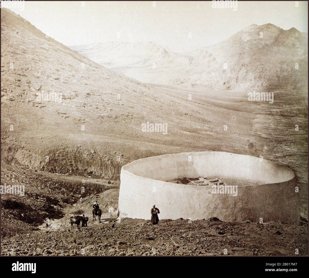 Iran: A Parsi 'Tower of Silence' near Tehran, photographed by Sven Hedin (19 February 1865 - 26 November 1952), c. 1898.  A Tower of Silence or Dakhma is a circular, raised structure used by Zoroastrians for exposure of the dead. There is no standard technical name for such a construction. The common dakhma or dokhma (from Middle Persian dakhmag) originally denoted any place for the dead. Similarly, in the medieval texts of Zoroastrian tradition, the word astodan appears, but today denotes an ossuary. In the Iranian provinces of Yazd and Kerman, the technical term is deme or dema. Stock Photo