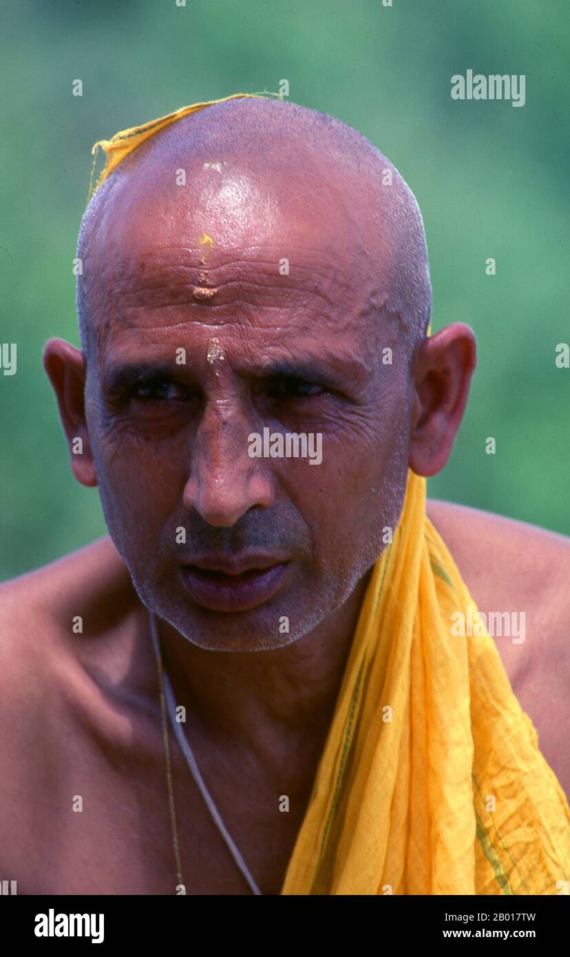 Nepal: Hindu Brahmin priest, Kathmandu.  A Brahmin (also Brahman) is a member of the priestly class in the Indian subcontinent and belongs to the upper caste society. In Hinduism, Brahmins were charged with performing religious duties as priests and preaching Dharma (as 'one who prays; a devout or religious man; a Brāhman who is well versed in Vedic texts; one versed in sacred knowledge'). Stock Photo