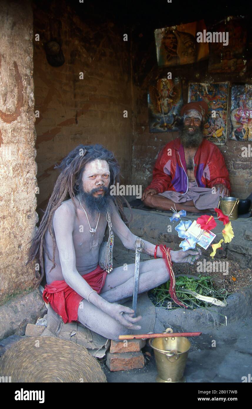 Nepal: Yogis, Budhanilkantha, Kathmandu Valley.  They are known, variously, as sadhus (saints, or 'good ones'), yogis (ascetic practitioners), fakirs (ascetic seeker after the Truth) and sannyasins (wandering mendicants and ascetics). They are the ascetic – and often eccentric – practitioners of an austere form of Hinduism. Sworn to cast off earthly desires, some choose to live as anchorites in the wilderness. Others are of a less retiring disposition, especially in the towns and temples of Nepal's Kathmandu Valley. Stock Photo