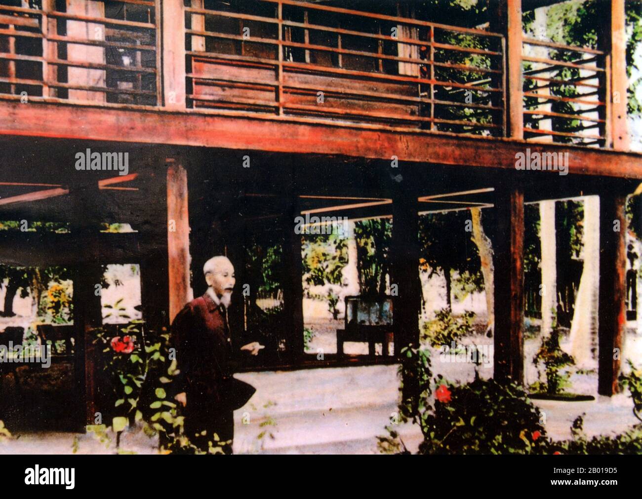 Vietnam: President Ho Chi Minh (19 May 1890 - 3 September 1969) in front of his wooden house in the grounds of the Presidential Palace, Hanoi, c. 1960.  Hồ Chí Minh, born Nguyễn Sinh Cung and also known as Nguyễn Ái Quốc was a Vietnamese Communist revolutionary leader who was prime minister (1946-1955) and president (1945-1969) of the Democratic Republic of Vietnam (North Vietnam). He formed the Democratic Republic of Vietnam and led the Viet Cong during the Vietnam War until his death. Stock Photo