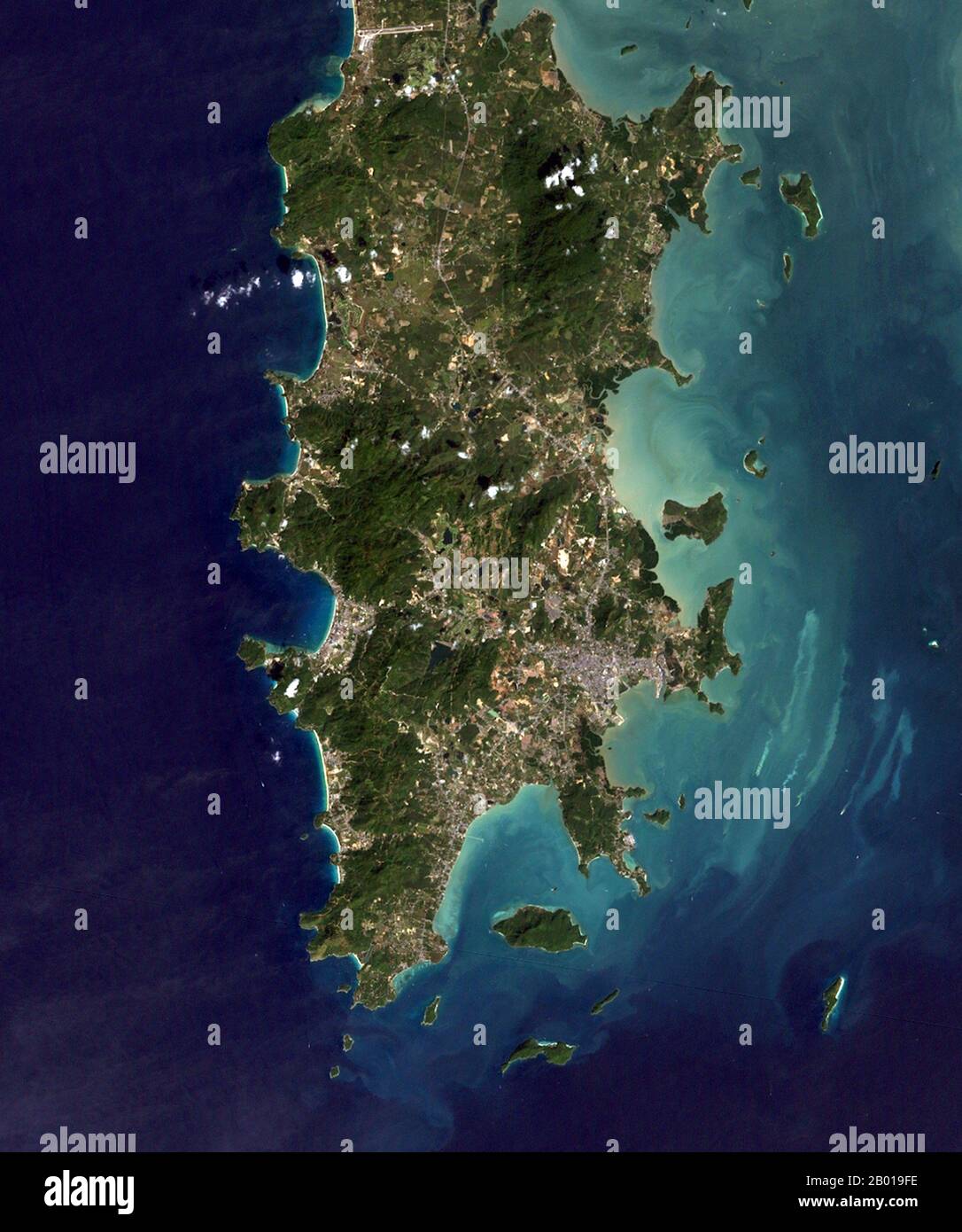 Thailand: Phuket Island and the surrounding Andaman Sea from space, 2004.  Phuket, formerly known as Talang and, in Western sources, Junk Ceylon (a corruption of the Malay Tanjung Salang, i.e. 'Cape Salang'), is one of the southern provinces (changwat) of Thailand. Neighbouring provinces are (from north clockwise) Phang Nga and Krabi, but as Phuket is an island there are no land boundaries.  Phuket, which is approximately the size of Singapore, is Thailand’s largest island. Connected to mainland Thailand by two bridges, it is situated off the west coast of Thailand in the Andaman Sea. Stock Photo