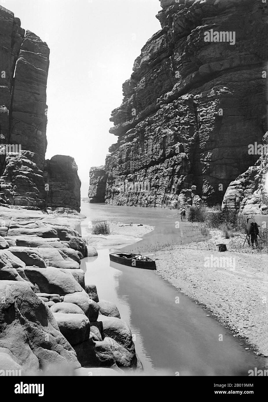 Jordan: The Arnon River (Wadi Mujib) Gorge, c. 1898-1914.  The Arnon is a river and wadi in western Jordan, known in modern times in Arabic as Wadi Mujib. Its length is about 72 km (45 miles), from its highlands in the desert to its entrance into the Dead Sea. It broadens to a width of 30 metres (100 feet) locally, but for the most part is narrow. Though low in summer, it runs as a torrent in the rainy winter season and is 2 to 3 metres (8 or 10 feet) deep in places. Its course flows northwesterly, but downstream its course becomes westerly. Stock Photo