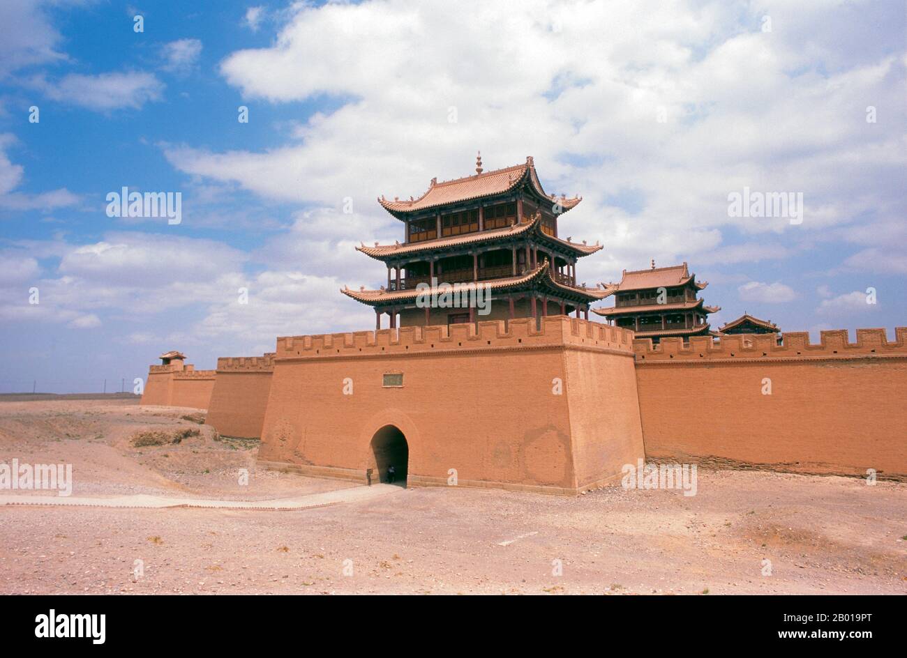 China: Western gate and tower at Jiayuguan Fort, Gansu Province.  Jiayuguan, the ‘First and Greatest Pass under Heaven’, was completed in 1372 on the orders of Zhu Yuanzhang, the first Ming Emperor (1368-98), to mark the end of the Ming Great Wall. It was also the very limits of Chinese civilisation, and the beginnings of the outer ‘barbarian’ lands. For centuries the fort was not just of strategic importance to Han Chinese, but of cultural significance as well. This was the last civilised place before the outer darkness, those proceeding beyond facing a life of exile among nomadic strangers. Stock Photo