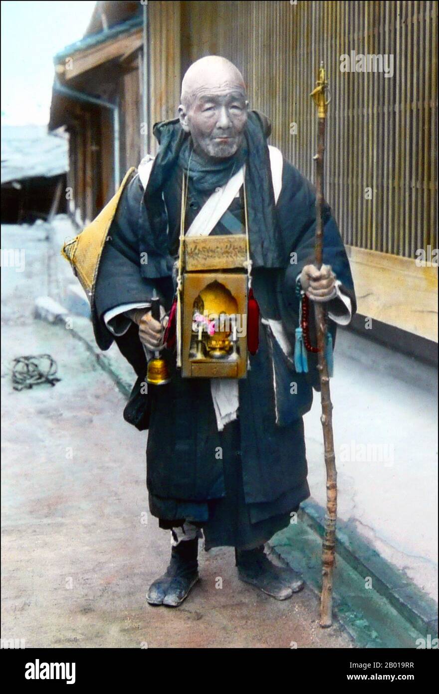 Japan: A mendicant pilgrim carrying a bell and a portable shrine around his neck. Photo by T. Enami (1859-1929), 1890s.  T. Enami (Enami Nobukuni) was the trade name of a celebrated Meiji period photographer. The T. of his trade name is thought to have stood for Toshi, though he never spelled it out on any personal or business document.  Born in Edo (now Tokyo) during the Bakumatsu era, Enami was first a student of, and then an assistant to the well known photographer and collotypist, Ogawa Kazumasa. Enami relocated to Yokohama, and opened a studio on Benten-dōri (Benten Street) in 1892. Stock Photo
