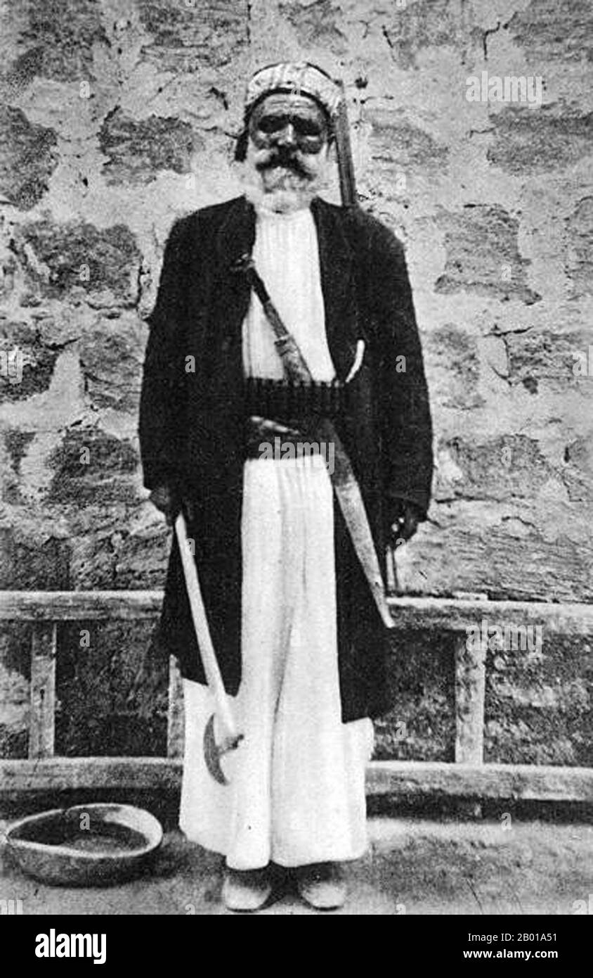 Syria: An Alawite man of Latakia. Postcard, c. 1900.  The Alawis, also known as Alawites, Nusayris and Ansaris, are a prominent mystical and syncretic religious group centred in Syria who constitute a branch of Shia Islam. Distinct Alawi beliefs include the belief that prayers are not necessary, they do not fast, perform pilgrimage, nor have specific places of worship. Traditionally Alawis live in the An-Nusayriyah Mountains along the Mediterranean coast of Syria. Latakia and Tartous are the region's principal cities. Alawis are also concentrated in the plains around Hama and Homs. Stock Photo