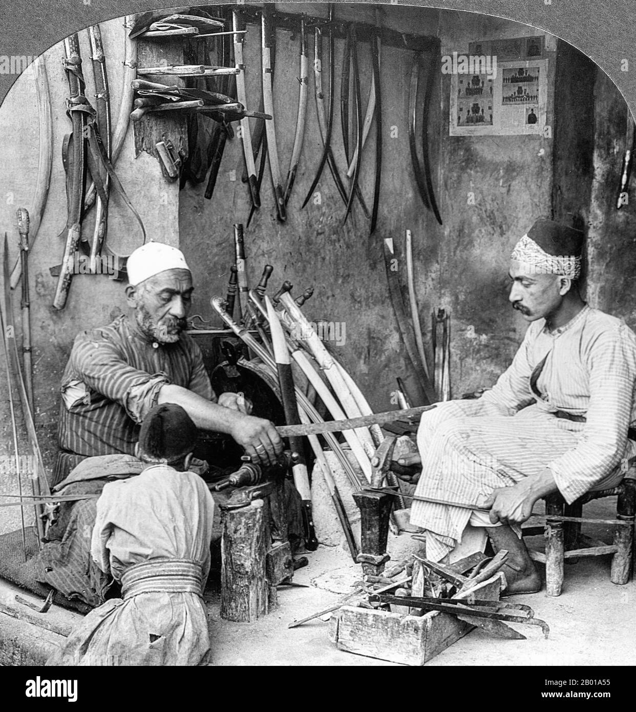 Syria: Sword-makers in Damascus, c. 1900.  Damascus steel was a term used by several Western cultures from the Medieval period onward to describe a type of steel used in swordmaking from about 300 BC to 1700 AD. These swords are characterized by distinctive patterns of banding and mottling reminiscent of flowing water. Such blades were reputed to be not only tough and resistant to shattering, but capable of being honed to a sharp and resilient edge. Stock Photo