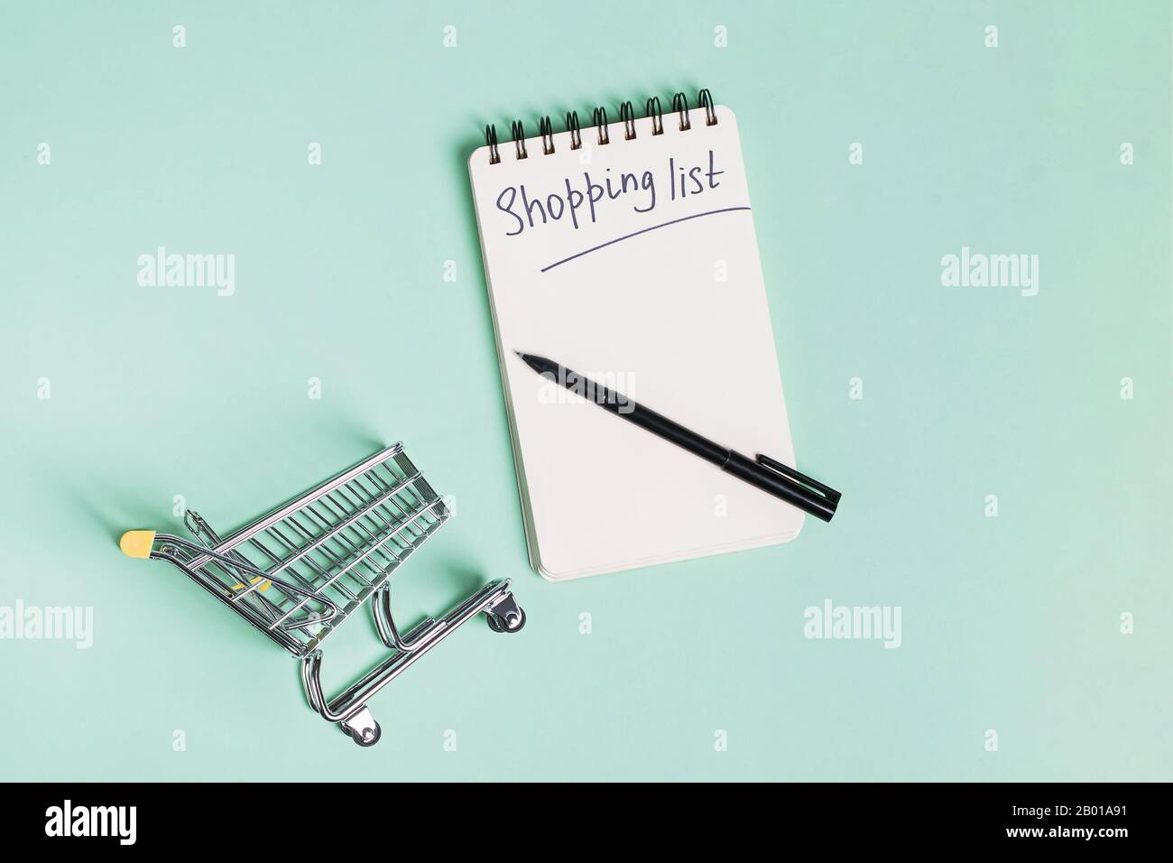 Small trolley, paper notepad and pen, top view Stock Photo