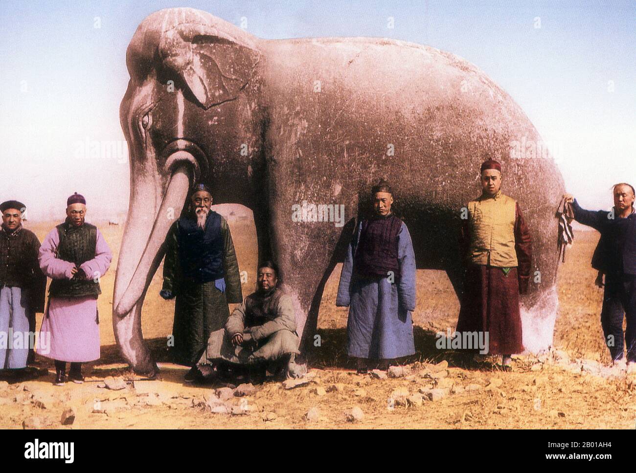 China: A group of well-to-do Chinese men posing in front of a stone elephant at the Ming Dynasty Tombs, 1872.  The Ming Dynasty Tombs ( Míng shísān líng; lit. Thirteen Tombs of the Ming Dynasty) are located some 50 kilometres due north of Beijing. The site was chosen by the third Ming Dynasty emperor Yongle (1402-1424), who moved the capital of China from Nanjing to the present location of Beijing.  Yongle is credited with envisioning the layout of the ancient city of Beijing as well as a number of landmarks and monuments located therein. Stock Photo