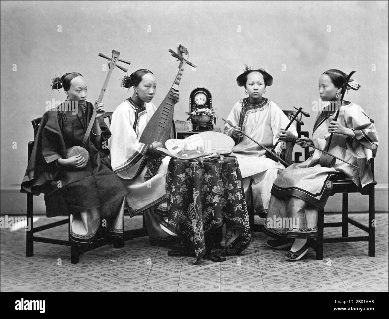 China: A musical quartet of Foochow (Fuzhou) singing girls. Photo by Lai Afong (1839-1890), c. 1868-1874.  Four Chinese female musicians playing from left to right; a sanxian, a pipa, an erxian and an erhu.  Lai Afong was a photographer who started Afong Studio, the most successful photographic studio of the late Qing Dynasty. He is commonly regarded as the most significant Chinese photographer of the 19th century. Stock Photo