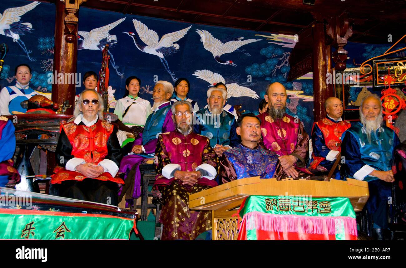 China: The Naxi Folk Orchestra, Naxi Orchestra Hall, Lijiang Old Town, Yunnan Province.  Naxi music is 500 years old, and with its mixture of literary lyrics, poetic topics, and musical styles from the Tang, Song, and Yuan dynasties, as well as some Tibetan influences, it has developed its own unique style and traits. There are three main styles: Baisha, Dongjing, and Huangjing, all using traditional Chinese instruments.  The Naxi/Nakhi are an ethnic group inhabiting the foothills of the Himalayas in the northwestern part of Yunnan Province, as well as the southwestern part of Sichuan Province Stock Photo