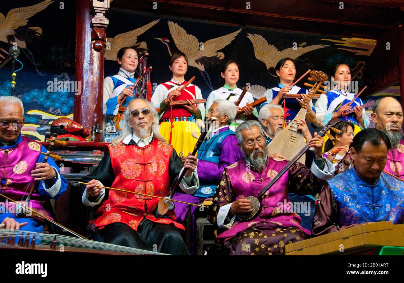 China: The Naxi (Nakhi) Folk Orchestra, Naxi Orchestra Hall, Lijiang Old Town, Yunnan Province.  Naxi music is 500 years old, and with its mixture of literary lyrics, poetic topics, and musical styles from the Tang, Song, and Yuan dynasties, as well as some Tibetan influences, it has developed its own unique style and traits. There are three main styles: Baisha, Dongjing, and Huangjing, all using traditional Chinese instruments.  The Naxi or Nakhi are an ethnic group inhabiting the foothills of the Himalayas in the northwestern part of Yunnan Province. Stock Photo