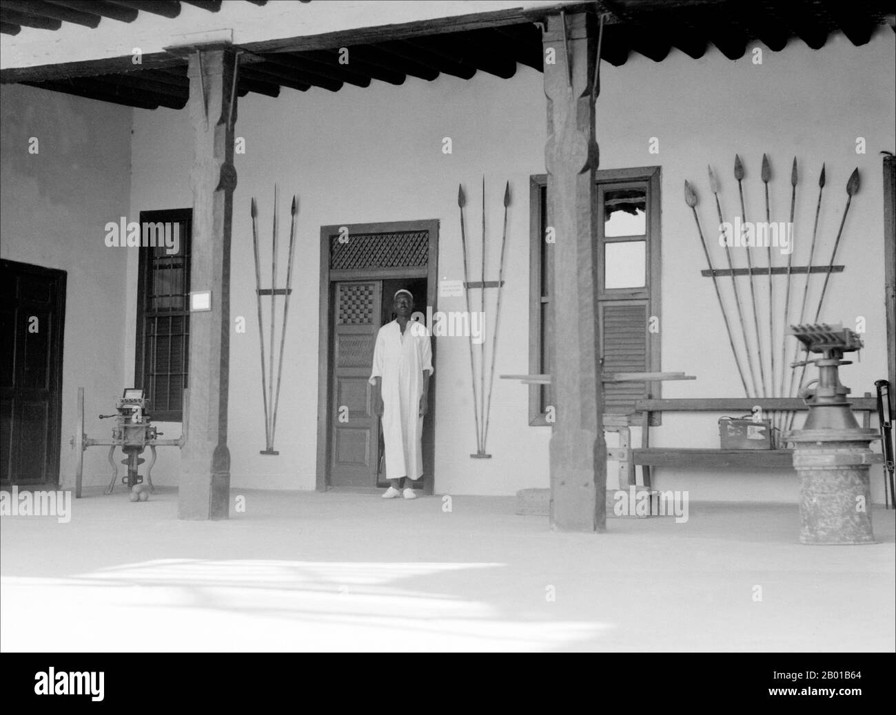 Sudan: A door keeper at the house of the former Mahdi, Omdurman, 1936.  Muhammad Ahmad bin Abd Allah (12 August 1844 - 22 June 1885) was a religious leader of the Samaniyya order in Sudan who, on June 29, 1881, proclaimed himself as the Mahdi or messianic redeemer of the Islamic faith. His proclamation came during a period of widespread resentment among the Sudanese population of the oppressive policies of the Turco-Egyptian rulers, and capitalised on the messianic beliefs popular among the various Sudanese religious sects of the time. Stock Photo