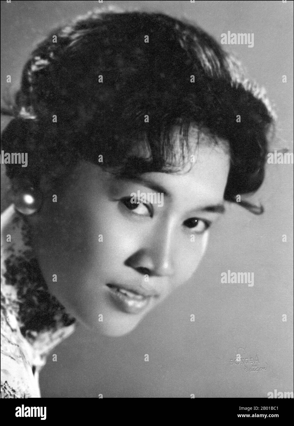 Vietnam: Portrait of a young Vietnamese woman in Saigon, c. 1960s.  Photograph of an attractive unknown young woman in Saigon in the 1960s wearing an ao dai and with a 1960s hairstyle. Stock Photo