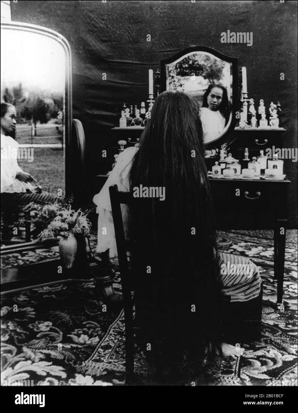 Thailand: Dara Rasmi (26 August 1873 - 9 December 1933), Princess of Chiang Mai and Siam posing with mirrors to display her long hair. Photo by Abe Bunnak (fl. early 20th century), 1905.  Princess Dara Rasmi was the Princess of Chiang Mai and Siam (later Thailand) and the daughter of King Inthawichayanon and Queen Thipkraisorn Rajadewi of Chang Mai, a scion of the Chao Chet Ton Dynasty. She was one of the princess consorts of Chulalongkorn, King Rama V of Siam, and gave birth to one daughter by King Chulalongkorn, Princess Vimolnaka Nabisi. Stock Photo