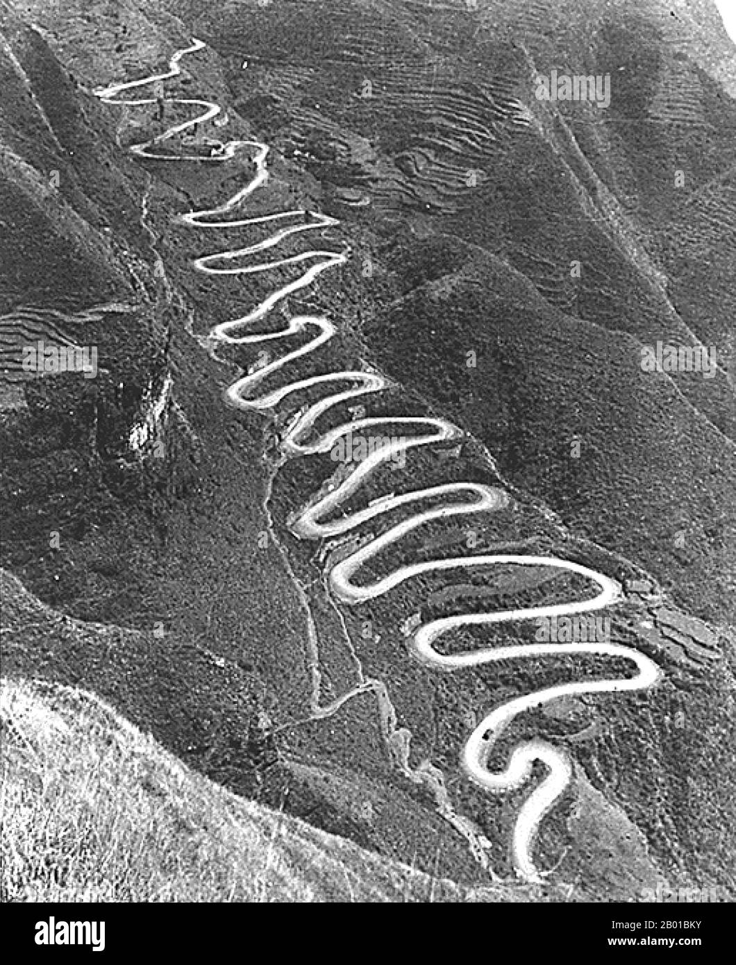 Burma/Myanmar/China: A convoy of military trucks on a section of the Burma Road, c. 1945.  The Burma Road is a road linking Burma (also called Myanmar) with China. Its terminals are Kunming, Yunnan, and Lashio, Burma. When it was built, Burma was a British colony under Japanese occupation.  The road is 717 miles (1,154 km) long and runs through rough mountain country. The sections from Kunming to the Burmese border were built by 200,000 Chinese laborers during the Second Sino-Japanese War in 1937 and completed by 1938. It had a role in World War II, when the British used the Burma Road. Stock Photo