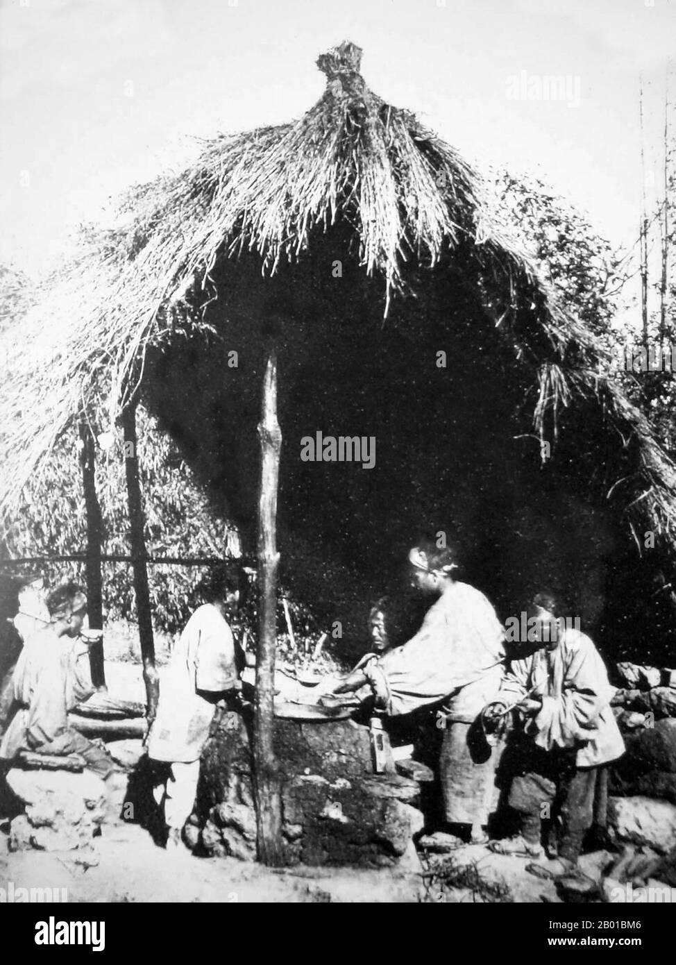 China: A simple restaurant by the Tea Horse Road in western Yunnan, c. 1900.  The Tea Horse Road (Cha Ma Dao) was a network of mule caravan paths winding through the mountains of Yunnan, Sichuan and Tibet in Southwest China. It is also sometimes referred to as the Southern Silk Road and Ancient Tea Horse Road. From around a thousand years ago, the Ancient Tea Route was a trade link from Yunnan, one of the first tea-producing regions, to India via Burma, to Tibet, and to central China via Sichuan Province. Stock Photo