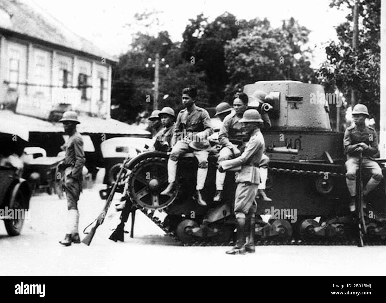Thailand: Troops with a light tank on the streets of Bangkok after the democratic coup of 1932.  Before 1932, the Kingdom of Siam did not possess a legislature, as all legislative powers were vested in the person of the monarch. This has been the case since the foundation of the Sukhothai Kingdom in the 12th century, as the king was seen as a 'Dharmaraja' or King who rules in accordance with the Buddhist law of righteousness. However on 24 June 1932 a group of civilians and military officers, calling themselves the Khana Ratsadon (or People's Party) carried out a bloodless revolution. Stock Photo