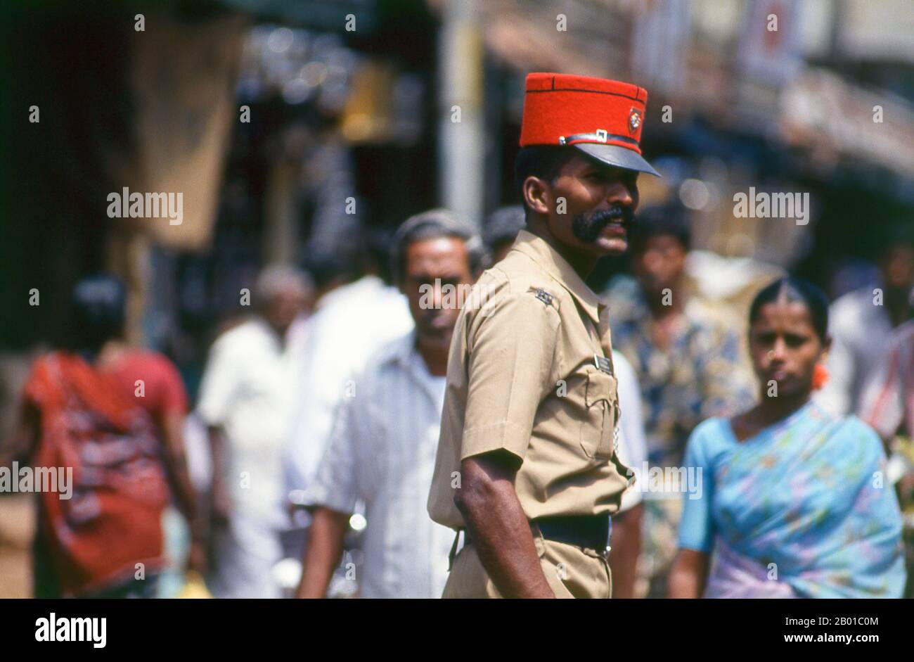 India: Pondi policeman in red kepi, Pondicherry.  Pondicherry was the capital of the former French territories in India. Besides Pondi itself – acquired from a local ruler in 1674 – these included Chandernagore in Bengal (1690); Mahé in Kerala (1725); Yanam in Andhra Pradesh (1731); and Karaikal in Tamil Nadu (1739). Chandernagore was returned to India three years after independence, in 1951, and was absorbed into West Bengal. Returned to India in 1956, the remaining four territories were constituted as the Union Territory of Pondicherry in 1962. Stock Photo