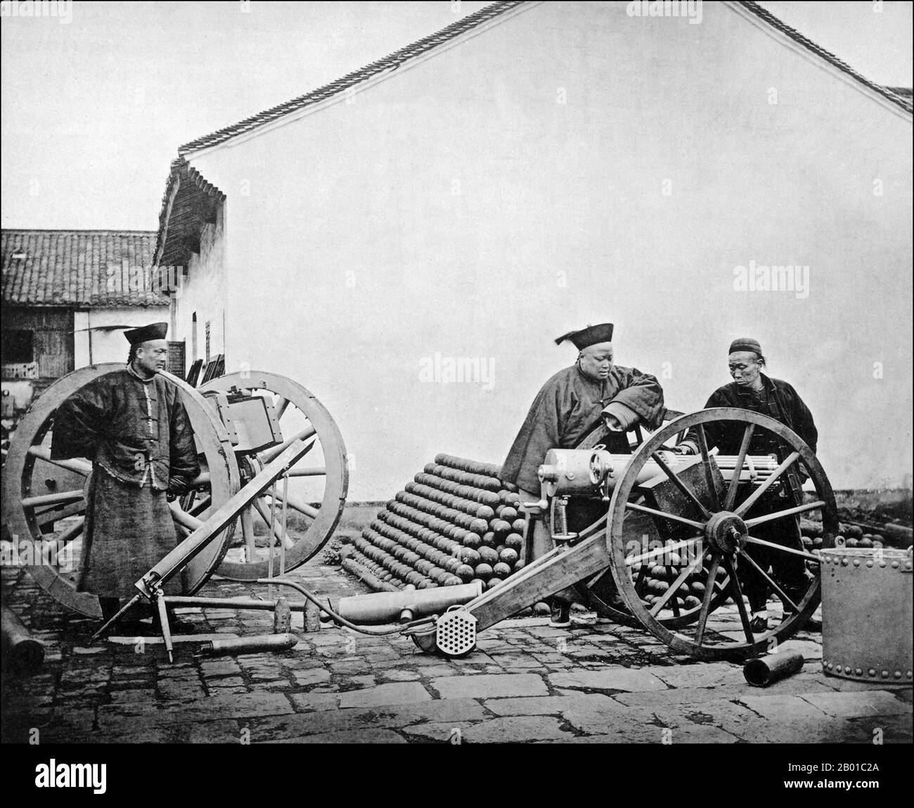 China: Qing officers posing at the Nanjing Jinling Arsenal, built by Li Hongzhang (15 February 1823 - 7 November 1901) in 1865. Photo by John Thomson (1837-1921), 1872.  Li Hongzhang (Wade–Giles: Li Hung-chang), Marquis Suyi of the First Class, was a Chinese civilian official who ended several major rebellions, and a leading statesman of the late Qing Empire. He served in important positions of the Imperial Court, once holding the office of the Viceroy of Zhili.   His image in China remains largely controversial. Stock Photo