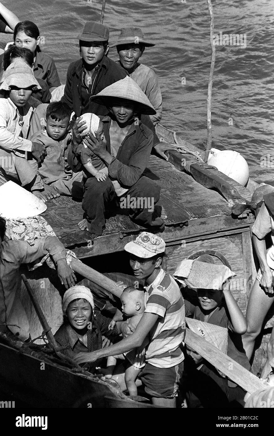 Vietnam: A group of refugee 'boat people' escaping from communist rule in the South China Sea. Photo by Lt. Carl R. Begy (public domain), 15 May 1984.  35 Vietnamese refugees rescued by the command ship USS Blue Ridge (LCC-19) northeast of Cam Ranh Bay, after spending eight days at sea.  Boat people is a term that usually refers to refugees or asylum seekers who emigrate in numbers in boats that are sometimes old and crudely made. The term came into common use during the late 1970s with the mass departure of Vietnamese refugees from Communist-controlled Vietnam, following the Vietnam War. Stock Photo