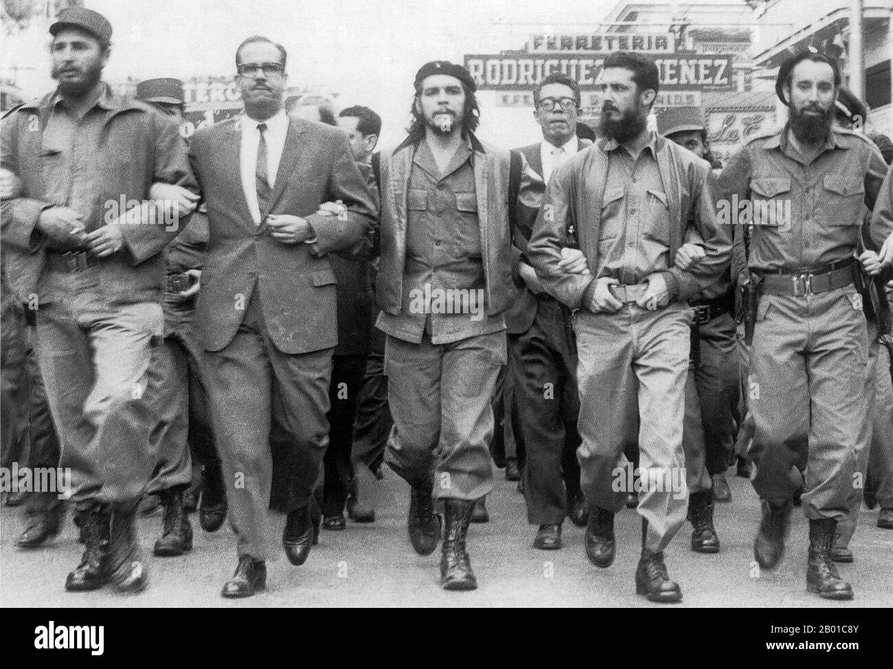 Cuba: 5 March 1960: Memorial service march for victims of the La Coubre explosion in Havana. On the far left of the photo is Fidel Castro, while in the centre is Che Guevara.  The freighter La Coubre exploded at 3:10 p.m. on 4 March 1960, while it was being unloaded in Havana harbour, Cuba. This 4,310-ton French vessel was carrying 76 tons of Belgian munitions from the port of Antwerp. Unloading explosive ordnance directly onto the dock was against port regulations. Ships with such cargoes were supposed to be moored in the centre of the harbour and their high-risk cargo unloaded onto lighters. Stock Photo