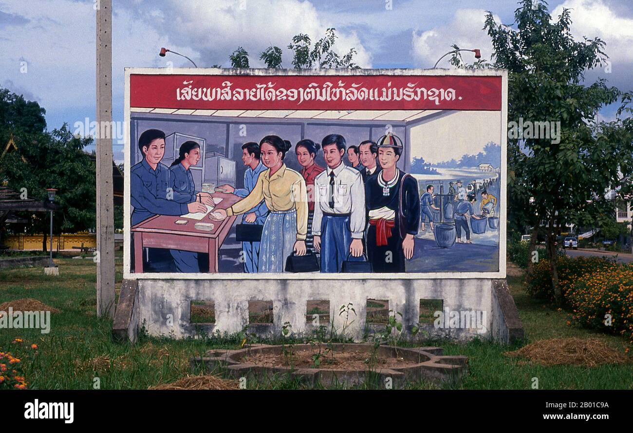 Laos: Revolutionary Socialist realist-style political poster on the streets of Vientiane.  Socialist realism is a style of realistic art which was developed in the Soviet Union and became a dominant style in other communist countries. Socialist realism is a teleologically-oriented style having its purpose the furtherance of the goals of socialism and communism. Although related, it should not be confused with social realism, a type of art that realistically depicts subjects of social concern. Unlike social realism, socialist realism often glorifies the roles of the poor. Stock Photo