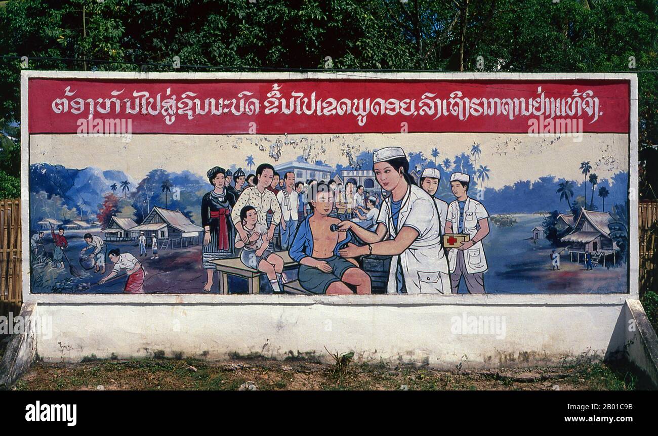 Laos: Revolutionary Socialist realist-style political poster on the streets of Vientiane.  Socialist realism is a style of realistic art which was developed in the Soviet Union and became a dominant style in other communist countries. Socialist realism is a teleologically-oriented style having its purpose the furtherance of the goals of socialism and communism. Although related, it should not be confused with social realism, a type of art that realistically depicts subjects of social concern. Unlike social realism, socialist realism often glorifies the roles of the poor. Stock Photo