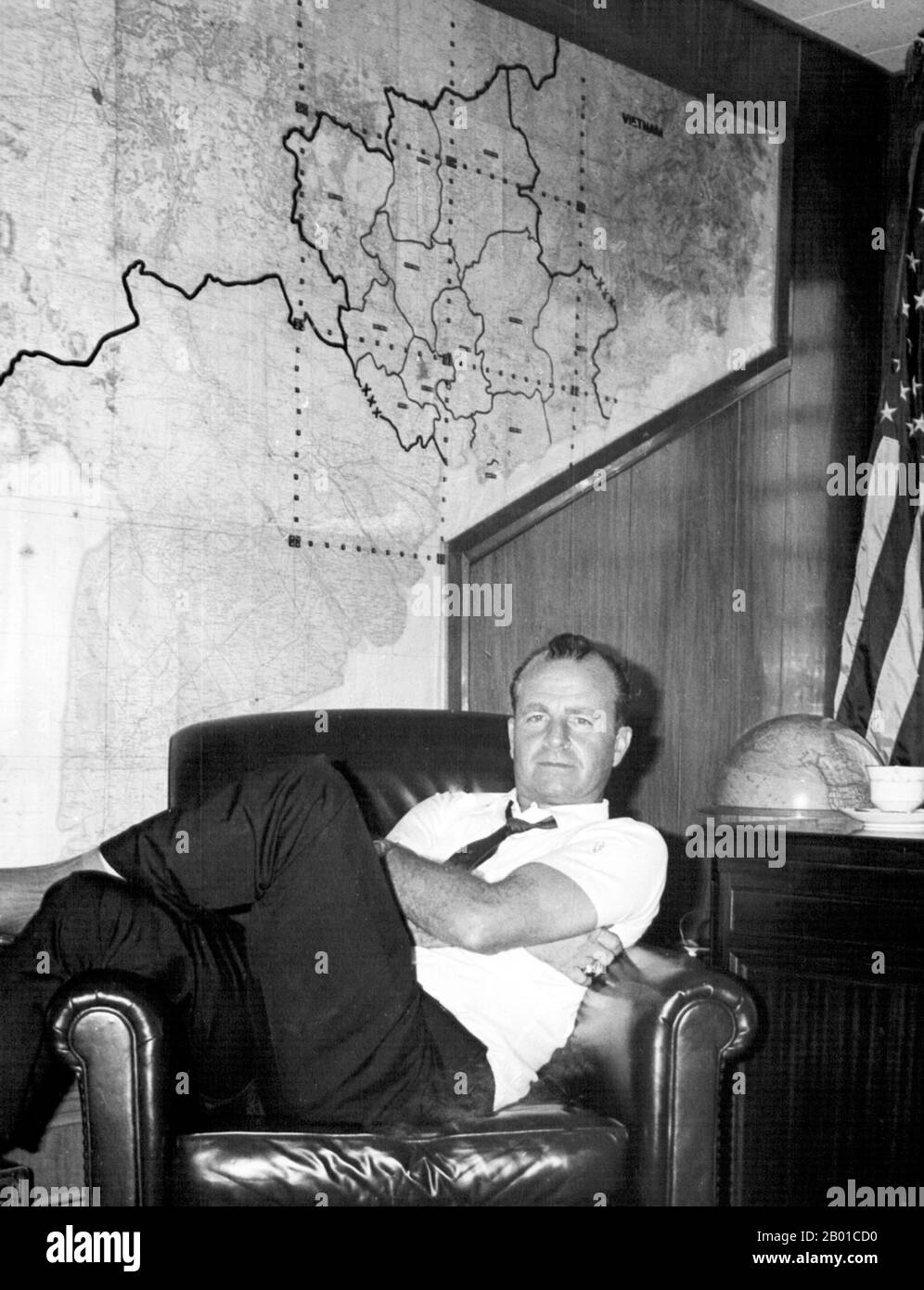 Vietnam: John Paul Vann (2 July 1924 - 9 June 1972) relaxing in his office in Saigon, c. 1966.  John Paul Vann was a Lieutenant Colonel in the United States Army, later retired, who became well-known for his role in the Vietnam War, especially in the Central Highlands and around Kontum. Although a civilian by the time the Vietnam War reached its zenith, he returned to active service under the auspices of the United States Agency for International Development, becoming the first civilian to command troops in regular combat there. Vann died in a helicopter crash in the Central Highlands in 1972. Stock Photo