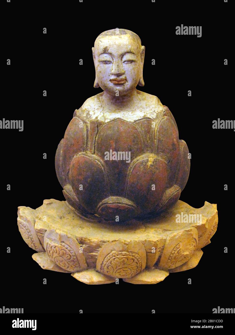 Vietnam: The boy Buddha rising up from lotus. Crimson and gilded wood, Trần-Hồ Dynasty, 14th-15th century. Photo by Gryffindor - Jbarta (CC BY-SA 3.0 License).  In Buddhism, in the Anguttara Nikaya, the Buddha compares himself to a lotus, stating that the lotus flower rises from the muddy water unsullied, free from the defilements taught in the specific sutta. Therefore the lotus symbolically represents purity of the body, speech and mind, floating beyond material attachment and physical desire.  Lotus thrones are the normal pedestal for most important Buddhist figures in art. Stock Photo