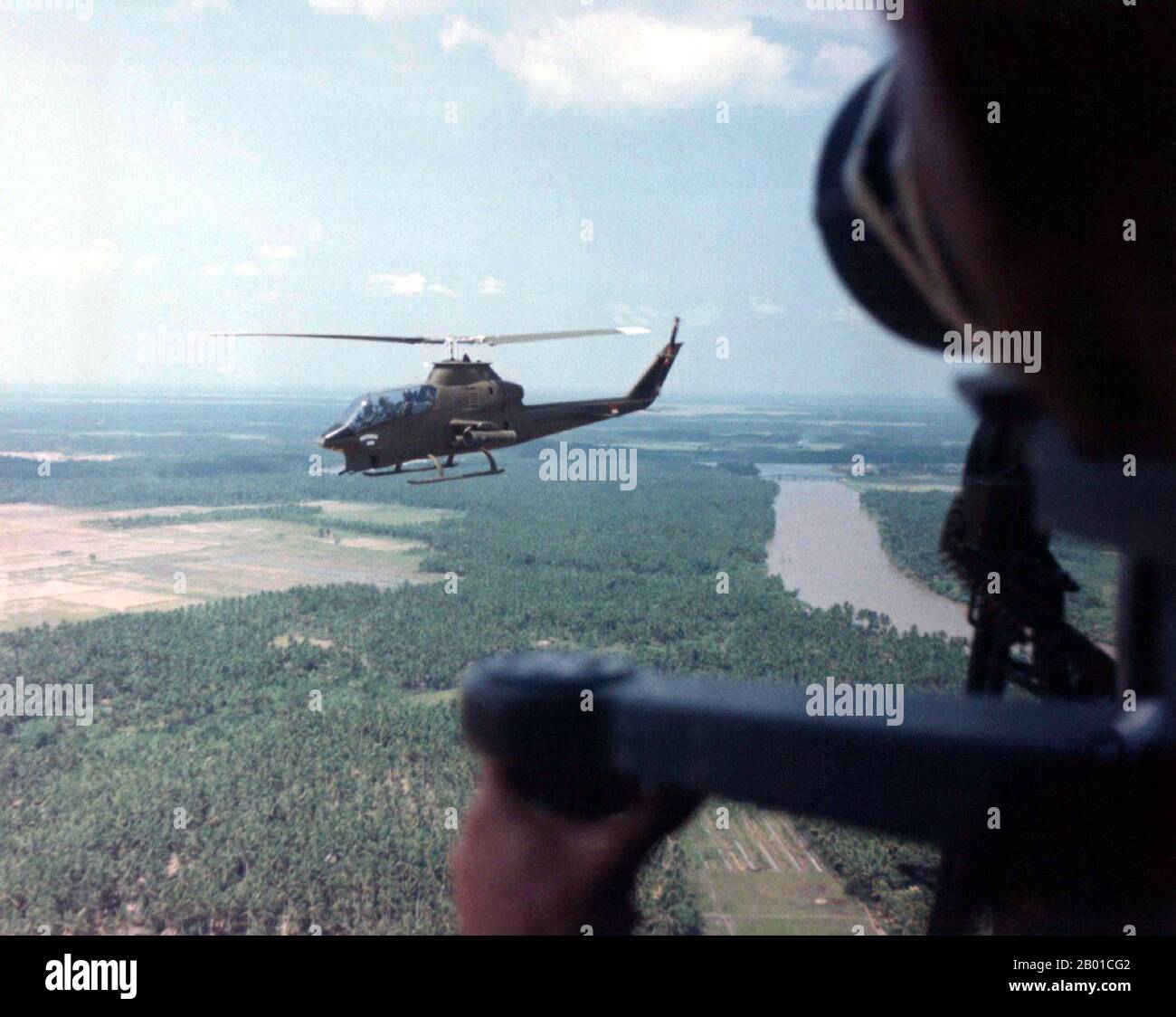 Vietnam: AH-1G Cobra helicopters over southern Vietnam, 1968.  The Second Indochina War, known in America as the Vietnam War, was a Cold War era military conflict that occurred in Vietnam, Laos, and Cambodia from 1 November 1955 to the fall of Saigon on 30 April 1975. This war followed the First Indochina War and was fought between North Vietnam, supported by its communist allies, and the government of South Vietnam, supported by the U.S. and other anti-communist nations. The U.S. government viewed involvement in the war as a way to prevent a communist takeover of South Vietnam. Stock Photo