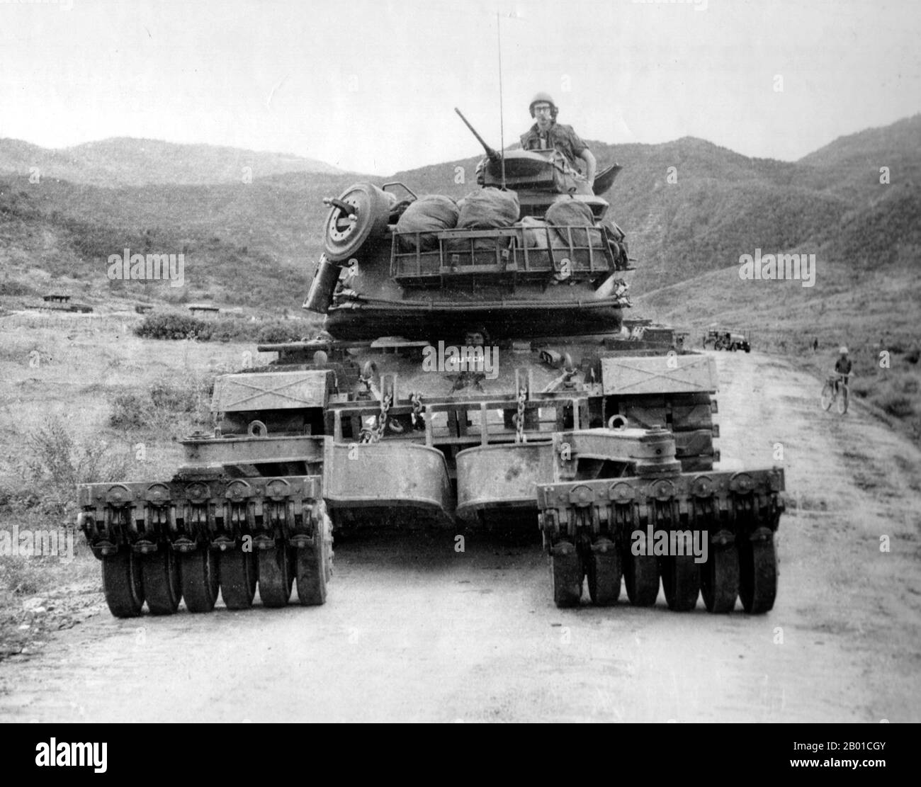 Vietnam: A tank-mounted mine roller on an M48 Patton clearing South Vietnam's Highway 19, c. 1966.  The Second Indochina War, known in America as the Vietnam War, was a Cold War era military conflict that occurred in Vietnam, Laos, and Cambodia from 1 November 1955 to the fall of Saigon on 30 April 1975. This war followed the First Indochina War and was fought between North Vietnam, supported by its communist allies, and the government of South Vietnam, supported by the U.S. and other anti-communist nations. Stock Photo