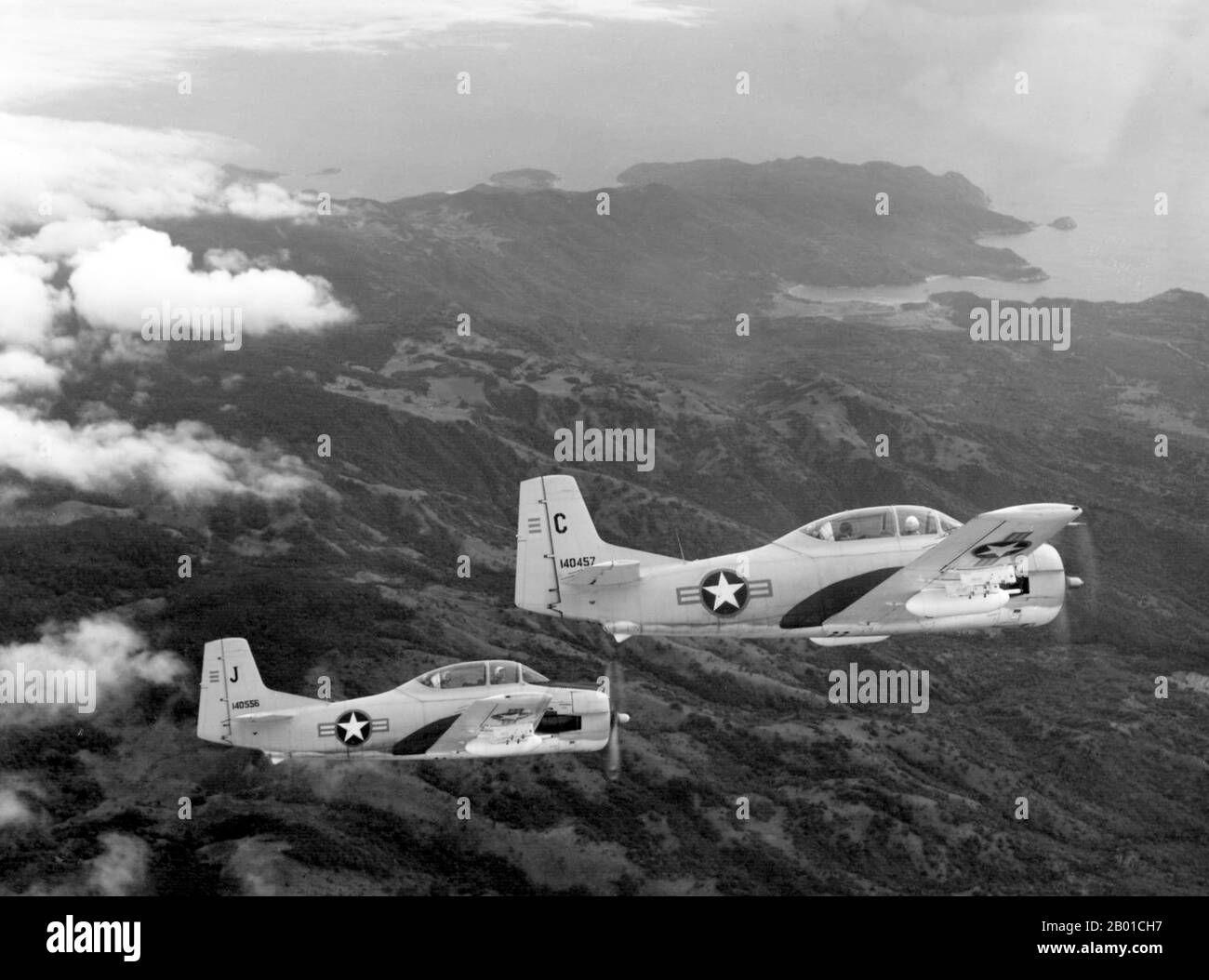 Vietnam: Two South Vietnamese Air Force North American T-28C Trojan aircraft flying over the Vietnamese coastline during a counterinsurgency training mission, 1962.  The Second Indochina War, known in America as the Vietnam War, was a Cold War era military conflict that occurred in Vietnam, Laos, and Cambodia from 1 November 1955 to the fall of Saigon on 30 April 1975. This war followed the First Indochina War and was fought between North Vietnam, supported by its communist allies, and the government of South Vietnam, supported by the U.S. and other anti-communist nations. Stock Photo