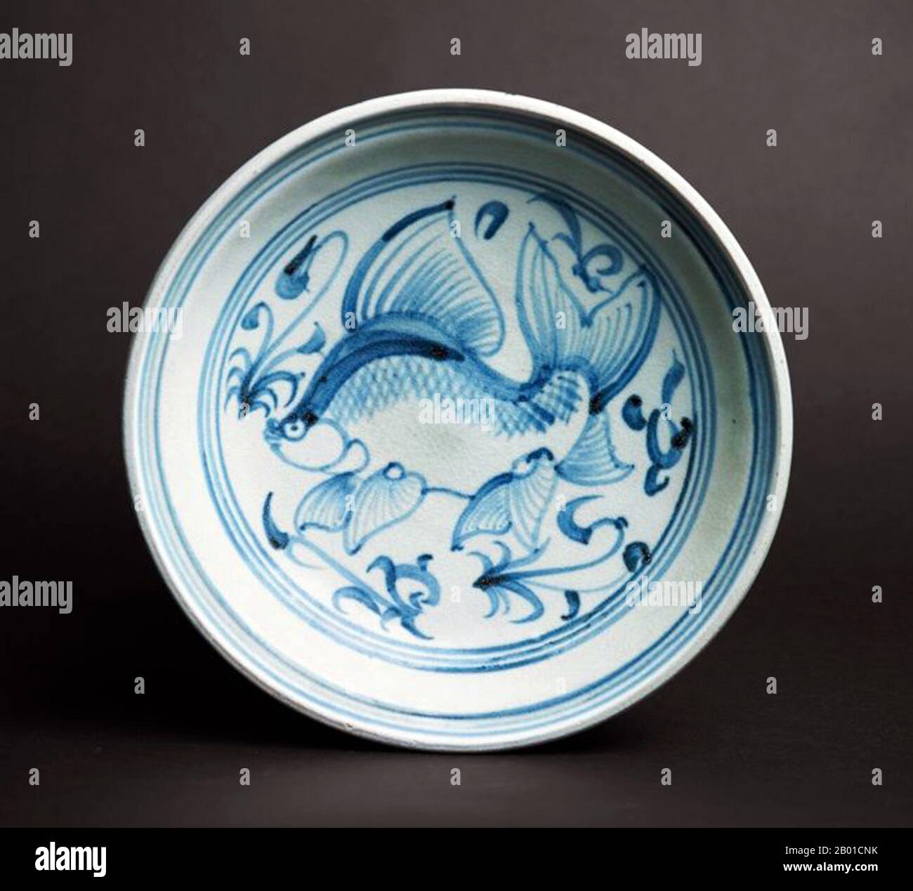 Vietnam: Blue and White Fish Plate with depiction of fish with extravagant fins swimming amongst water plants. Later Lê Dynasty (1533-1788).  Bát Tràng porcelain and pottery is a type of ceramics made in the village of Bát Tràng, in the suburban outskirts of the northern Vietnamese city of Hanoi. The village is located in an area rich in clay suitable for making fine ceramics.  Bát Tràng ceramics are considered some of the best known porcelain products in Vietnam besides those of Chu Đậu, Đồng Nai, Phu Lang, and Ninh Thuận. Stock Photo