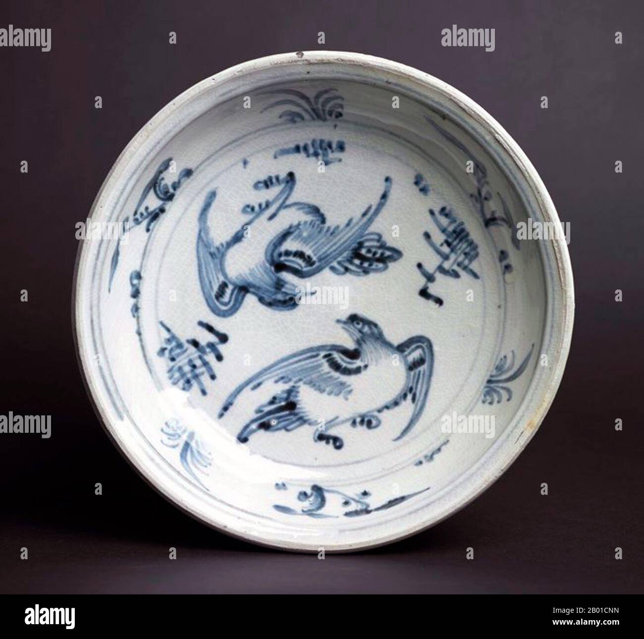 Vietnam: Blue and White plate with two birds flying around each other surrounded by various flora. Later Lê Dynasty (1533-1788).  Bát Tràng porcelain and pottery is a type of ceramics made in the village of Bát Tràng, in the suburban outskirts of the northern Vietnamese city of Hanoi. The village is located in an area rich in clay suitable for making fine ceramics.  Bát Tràng ceramics are considered some of the best known porcelain products in Vietnam besides those of Chu Đậu, Đồng Nai, Phu Lang, and Ninh Thuận. Stock Photo
