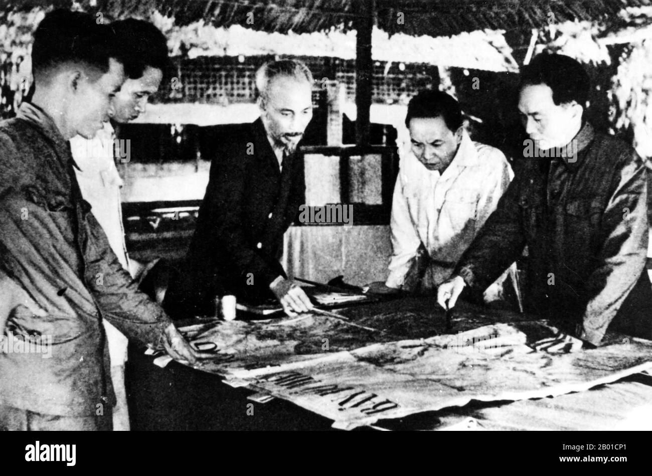 Vietnam: President Ho Chi Minh and General Vo Nguyen Giap study plans for the Dien Bien Phu campaign with colleagues, Viet Minh headquarters, Viet Bac, 1953.  The important Battle of Dien Bien Phu was fought between the Việt Minh (led by General Vo Nguyen Giap), and the French Union (led by General Henri Navarre, successor to General Raoul Salan). The siege of the French garrison lasted fifty-seven days, from 5:30PM on March 13 to 5:30PM on May 7, 1954.  The southern outpost or fire base of the camp, Isabelle, did not follow the cease-fire order and fought until the next day at 01:00 AM. Stock Photo