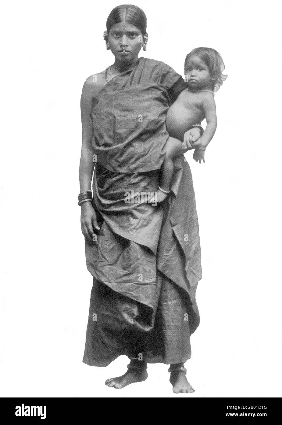 Sri Lanka: Sinhalese mother and child, late 19th century.  The Sinhalese are an Indo-Aryan ethnic group, forming the majority in Sri Lanka. They constitute 74% of the Sri Lankan population,  numbering approximately 15 million. They live mainly in central, south and west Sri Lanka. According to legend they are the descendants of the exiled Prince Vijaya who arrived from North-East India to Sri Lanka in 543 BCE.  The Sinhalese identity is based on language, heritage and religion. The vast majority of Sinhalese are Theravada Buddhists and speak Sinhala, an Indo-Aryan language. Stock Photo
