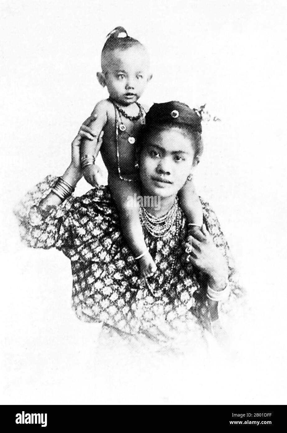 Burma: A Burman mother and her child, c. 1892-1896.  The British conquest of Burma began in 1824 in response to a Burmese attempt to invade India. By 1886, and after two further wars, Britain had incorporated the entire country into the British Raj. To stimulate trade and facilitate changes, the British brought in Indians and Chinese, who quickly displaced the Burmese in urban areas. To this day Rangoon and Mandalay have large ethnic Indian populations. Railways and schools were built, as well as a large number of prisons, including the infamous Insein Prison. Stock Photo