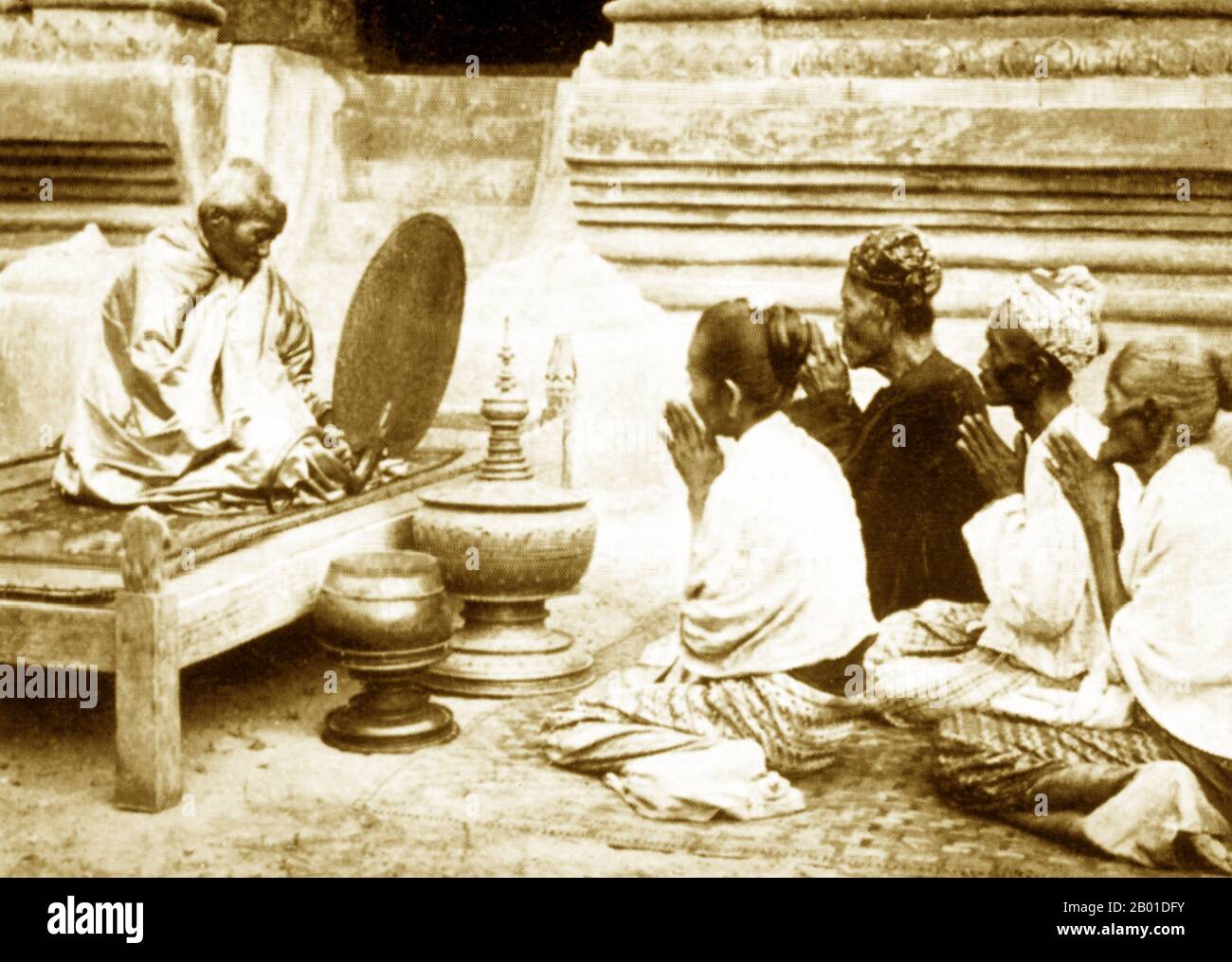 Burma: A Buddhist abbot (Burmese: 'sayadaw') recites precepts to devotees, c. 1892-1896.  Buddhist monks collect alms - food prepared by devotees and laypersons who make merit by donating it - every morning in Burma and most Theravada Buddhist countries. This is their only food for the day. Monks do not eat after 12 noon.  Legend attributes the first Buddhist doctrine in Burma to 228 BC when Sonna and Uttara, two ambassadors of the Emperor Ashoka the Great of India, came to the country with sacred texts. However, the golden era of Buddhism truly began in the 11th century. Stock Photo