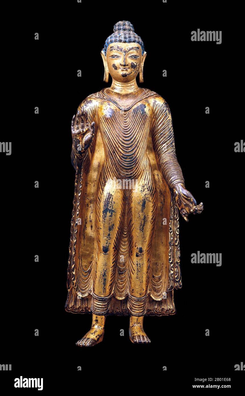 India: Gilded copper standing Buddha image in Abhaya mudrā ('mudrā of no-fear'), Kashmir, c. 7th-8th centuries CE.  Siddhārtha Gautama (Sanskrit: सिद्धार्थ गौतम; Pali: Siddhattha Gotama) was a spiritual teacher from ancient India who founded Buddhism. In most Buddhist traditions, he is regarded as the Supreme Buddha (P. sammāsambuddha, S. samyaksaṃbuddha) of our age, 'Buddha' meaning 'awakened one' or 'enlightened one'.  The time of his birth and death are uncertain: most early 20th-century historians dated his lifetime as c. 563 BCE to 483 BCE. Stock Photo