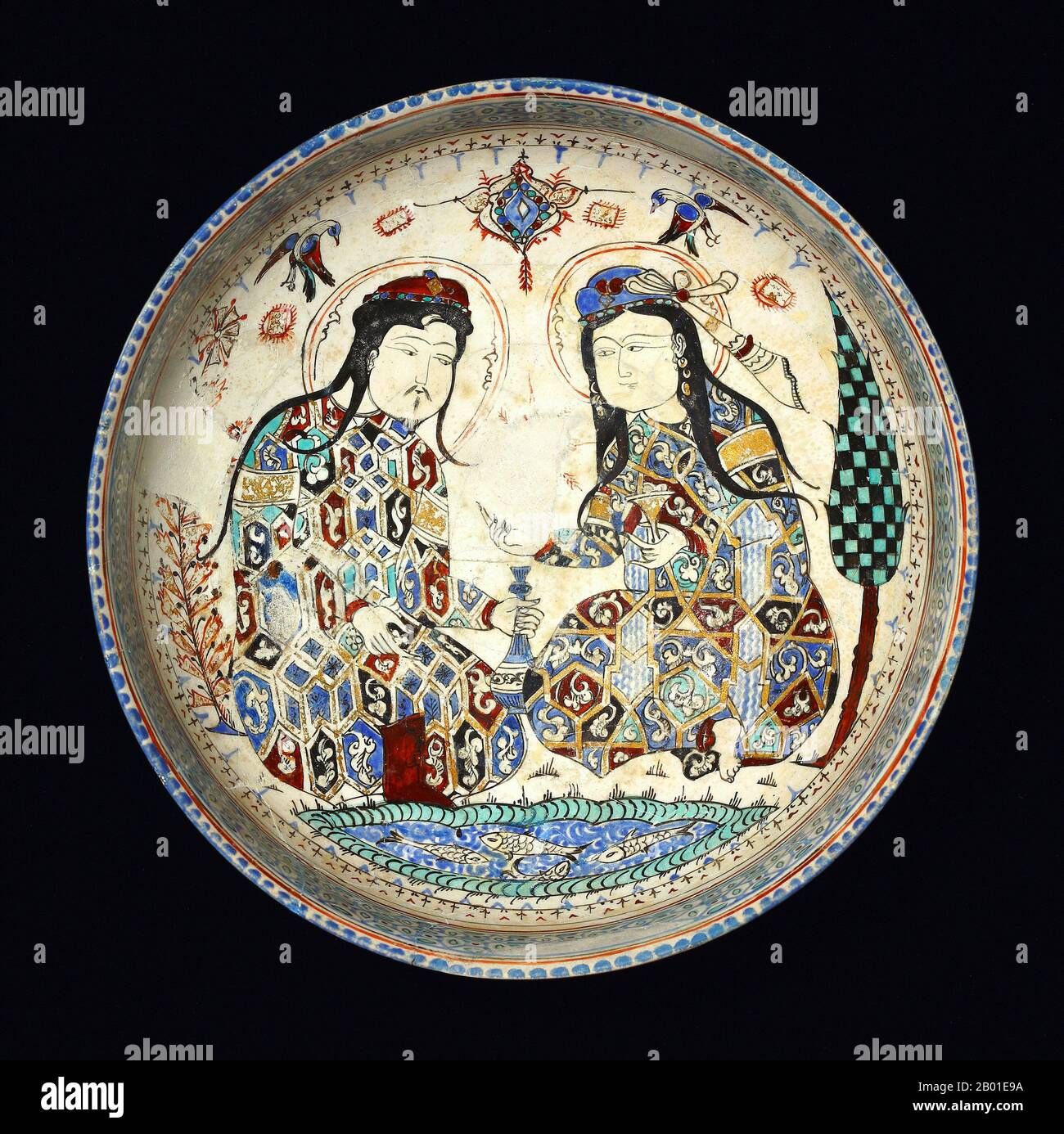 Iran/Persia: Mongol couple, late Khwarezmid or early Ilkhanid, represented on a painted, glazed plate, Kashan, 13th century.  The Ilkhanate, also spelled Il-khanate, was a Mongol khanate established in Azerbaijan and Persia in the 13th century, considered a part of the Mongol Empire.  The Ilkhanate was based, originally, on Genghis Khan's campaigns in the Khwarezmid Empire in 1219-1224, and founded by Genghis's grandson, Hulagu, in territories which today comprise most of Iran, Iraq, Afghanistan, Turkmenistan, Armenia, Azerbaijan, Georgia, Turkey, and some regions of western Pakistan. Stock Photo