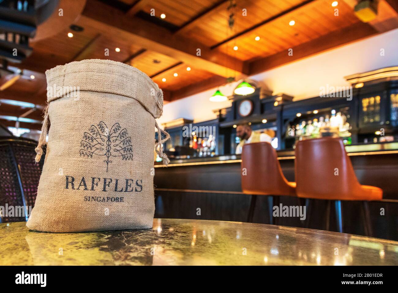Inside the famous Raffles Long Bar, Singapore showing a traditional bag of peanuts with the Raffles name on it, Singapore, Asia. Stock Photo