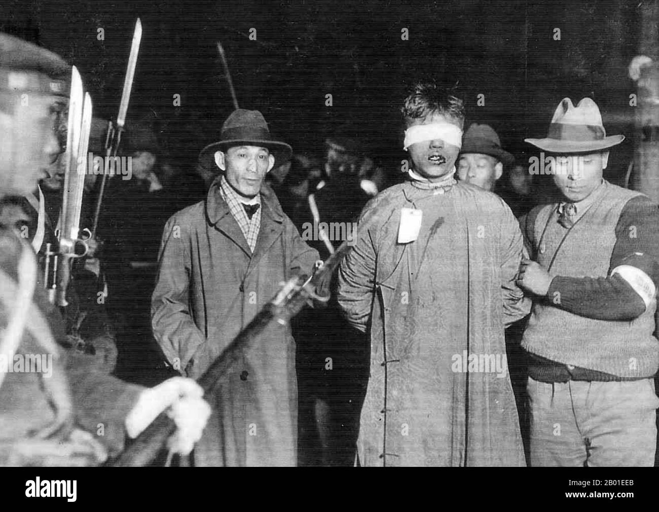 China: Chinese patriot held by Japanese agents, Zhabei, Shanghai, 1932.   A note in Chinese attached to the photograph records that the prisoner was murdered immediately after the photograph was taken.  The January 28 Incident (28 January 28 - 3 March 1932) was a short war between the armies of the Republic of China and the Empire of Japan, before official hostilities of the Second Sino-Japanese War commenced in 1937.  In Chinese literature it is known as the January 28 Incident, while in Western sources it is often called the Shanghai War of 1932 or, more simply, the Shanghai Incident. Stock Photo