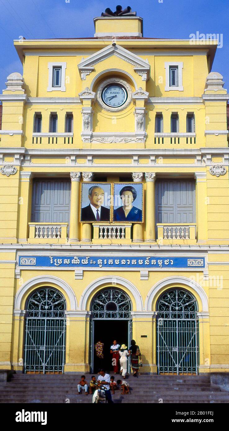 Cambodia: The Central Post Office with portraits of ex-King Sihanouk and his wife Queen Monique, Phnom Penh.  Phnom Penh lies on the western side of the Mekong River at the point where it is joined by the Sap River and divides into the Bassac River, making a meet place of four great waterways known in Cambodian as Chatomuk or 'Four Faces'. It has been central to Cambodian life since soon after the abandonment of Angkor in the mid-14th century and has been the capital since 1866. Stock Photo