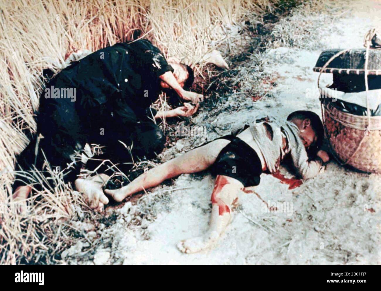 Vietnam: A male victim and child victim of the My Lai massacre or Thảm sát Mỹ Lai, March 6, 1868. Photo by Sgt. Ronald L. Haeberle.  The My Lai Massacre was the Vietnam War mass murder of 347–504 unarmed civilians in South Vietnam on March 16, 1968, by United States Army soldiers of 'Charlie' Company of 1st Battalion, 20th Infantry Regiment, 11th Brigade of the Americal Division.  Most of the victims were women, children (including babies), and elderly people. Many were raped, beaten, and tortured, and some of the bodies were later found to be mutilated. Stock Photo