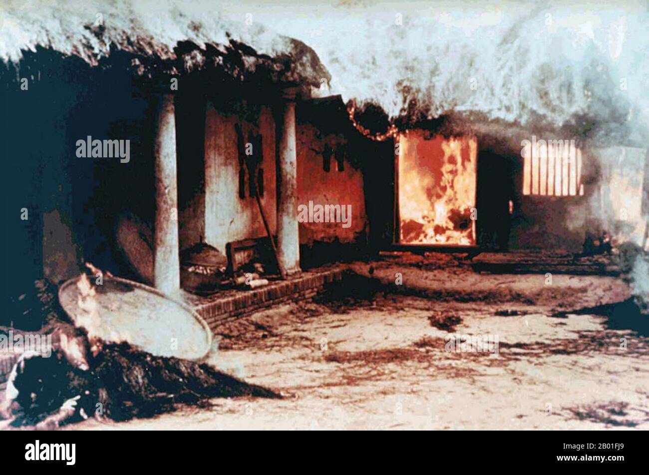 Vietnam: Unidentified bodies near burning house, My Lai, March 16, 1968. Photo by Sgt. Ronald L. Haeberle.  The My Lai Massacre was the Vietnam War mass murder of 347–504 unarmed civilians in South Vietnam on March 16, 1968, by United States Army soldiers of 'Charlie' Company of 1st Battalion, 20th Infantry Regiment, 11th Brigade of the Americal Division.  Most of the victims were women, children (including babies), and elderly people. Many were raped, beaten, and tortured, and some of the bodies were later found to be mutilated. Stock Photo