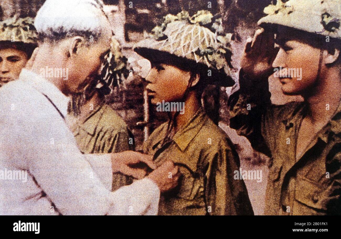 Vietnam: Ho Chi Minh giving medals for bravery after victory at Dien Bien Phu, 1954.  The important Battle of Dien Bien Phu was fought between the Việt Minh (led by General Vo Nguyen Giap), and the French Union (led by General Henri Navarre, successor to General Raoul Salan). The siege of the French garrison lasted fifty-seven days, from 5:30PM on March 13 to 5:30PM on May 7, 1954.  The southern outpost or fire base of the camp, Isabelle, did not follow the cease-fire order and fought until the next day at 01:00AM; a few hours before the long-scheduled Geneva Meeting's Indochina conference. Stock Photo