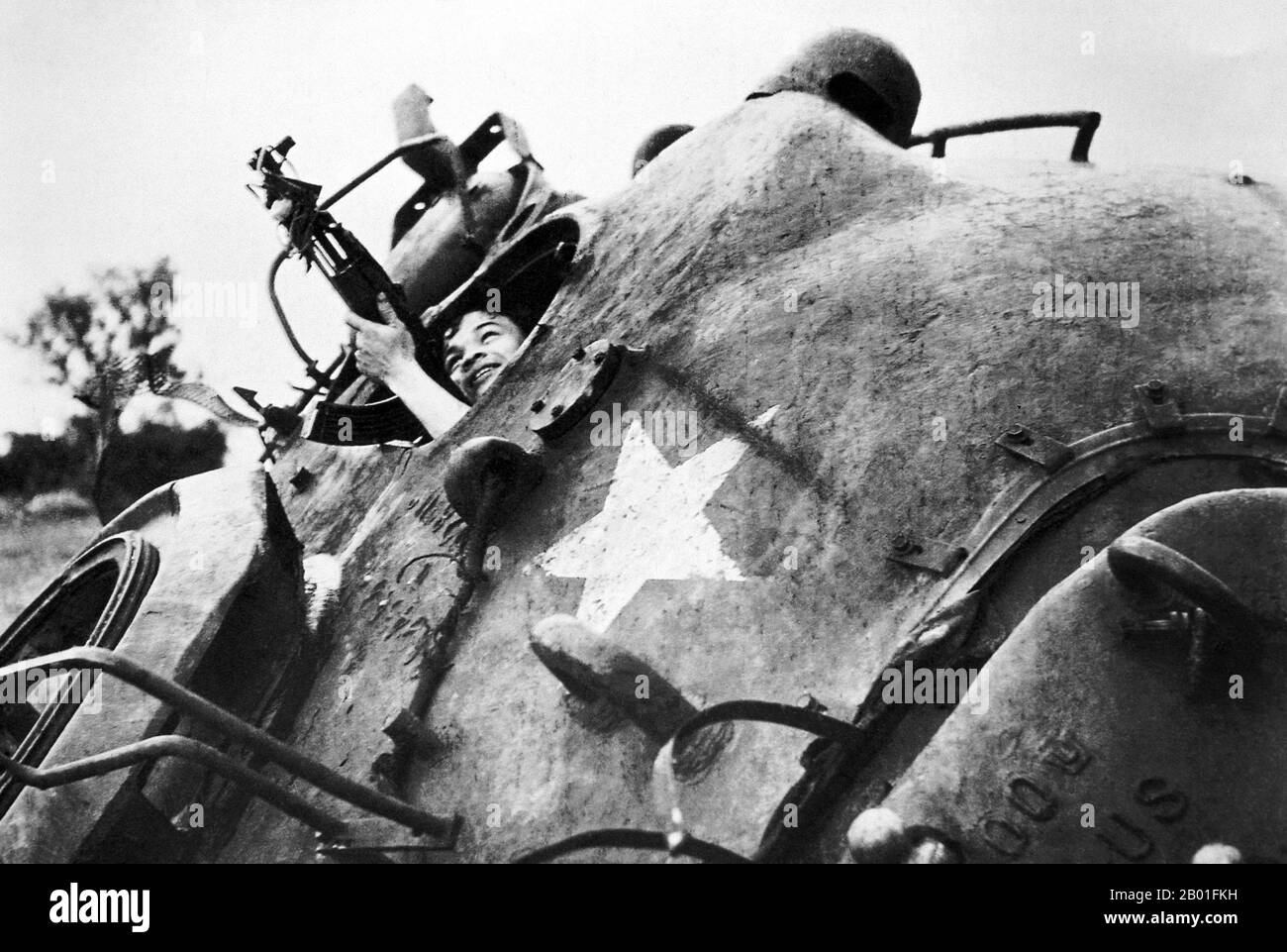 Vietnam: Using turret of destroyed US tank as cover, Cu Chi, 1968.  The Second Indochina War, known in America as the Vietnam War, was a Cold War era military conflict that occurred in Vietnam, Laos, and Cambodia from 1 November 1955 to the fall of Saigon on 30 April 1975. This war followed the First Indochina War and was fought between North Vietnam, supported by its communist allies, and the government of South Vietnam, supported by the U.S. and other anti-communist nations. The U.S. government viewed involvement in the war as a way to prevent a communist takeover of South Vietnam. Stock Photo