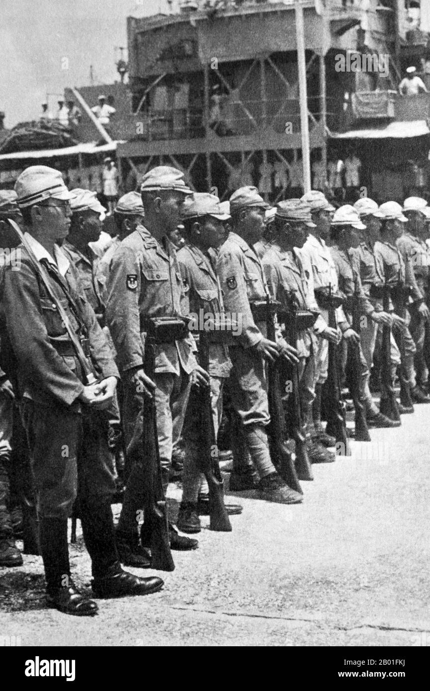 Vietnam: Armed Japanese troops in Saigon under British control after Japanese surrender, 1945.  In September 1945, 20,000 British troops of the 20th Indian Division occupied Saigon under the command of General Sir Douglas David Gracey. During the Potsdam Conference in July 1945, the Allies had agreed on Britain taking control of Vietnam south of the 16th parallel (then part of French Indochina) from the Japanese occupiers. Meanwhile, Ho Chi Minh proclaimed Vietnamese independence from French rule and major pro-independence and anti-French demonstrations were held in Saigon. Stock Photo