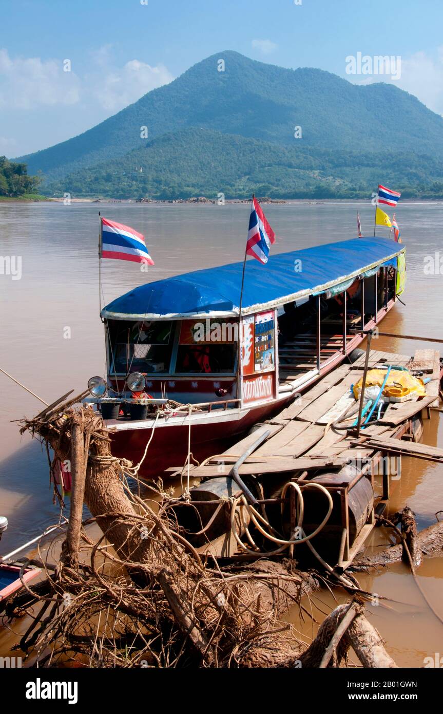 Thailand: Tour boats moored on the Mekong River at Kaeng Khut Khu, Loei Province.  Loei (Thai: เลย) Province is located in Thailand's upper North-East. Neighboring provinces are (from east clockwise) Nong Khai, Udon Thani, Nongbua Lamphu, Khon Kaen, Phetchabun, Phitsanulok. In the north it borders Xaignabouli and Vientiane Provinces of Laos.  The province is covered with low mountains, while the capital Loei is located in a fertile basin. The Loei River, which flows through the province, is a tributary of the Mekong. Stock Photo